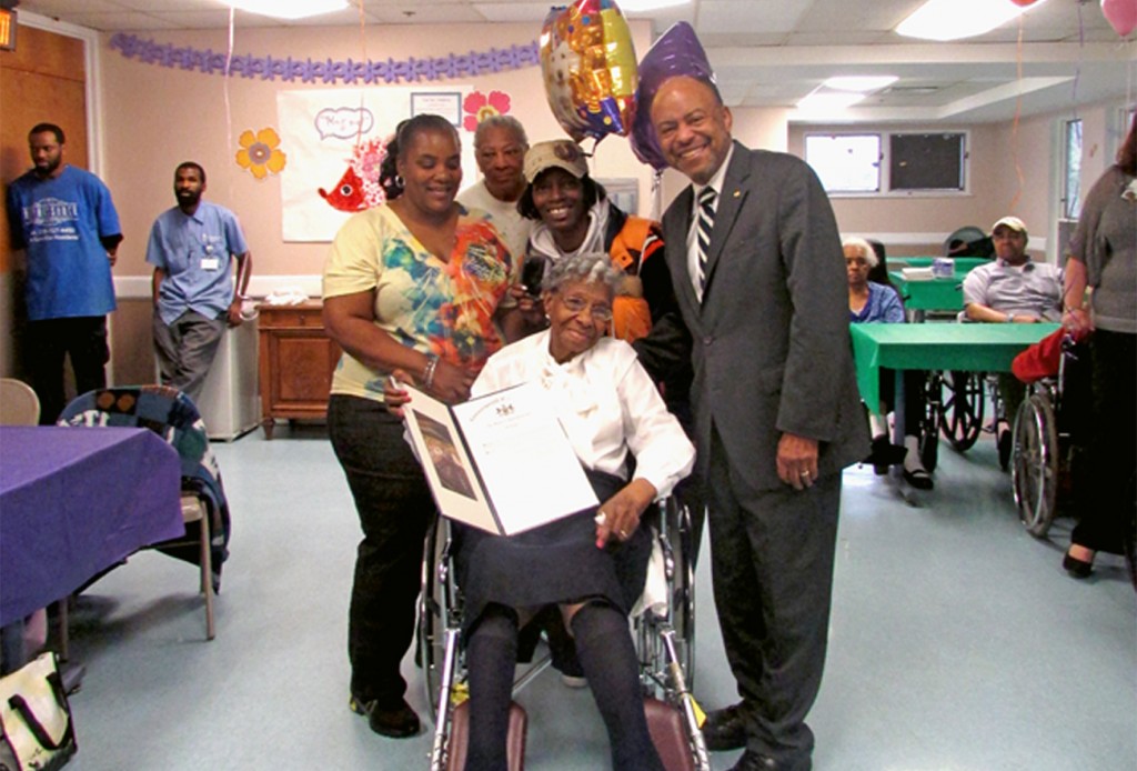 Rep. Roebuck presents Ms. Hills (center) with a citation. She is joined by granddaughter Bridgette Jones, and neighbors Joan Spellman and Angela Shomate (left to right). Shoemate said: “[Rosetta] told me she was here so long because God has a plan for her and she hasn’t did it yet.” 